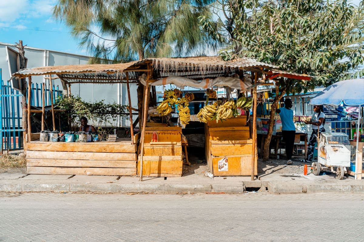 A roadside fruit stall with vendors in Nairobi, Kenya